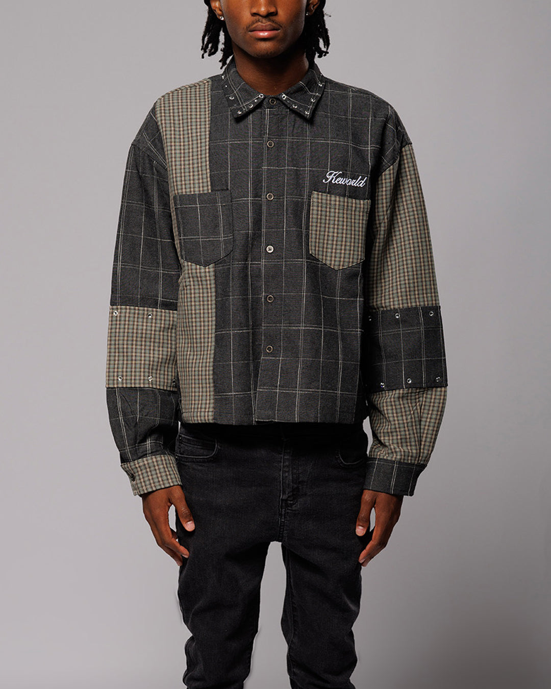 Person wearing a checkered shirt with 'Keworld" branding on a gray background